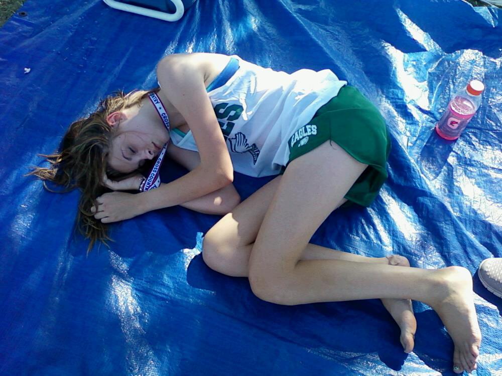 Allegra Knight rests after winning a 5th place medal at the PC North meet at Woodson Park on September 11. Temperatures soared into the mid-90s, and coupled with an Air Quality Alert for the OKC metro area that day, the meet was difficult for the cross country runners. Despite the conditions, the girls cross country team was successful.
