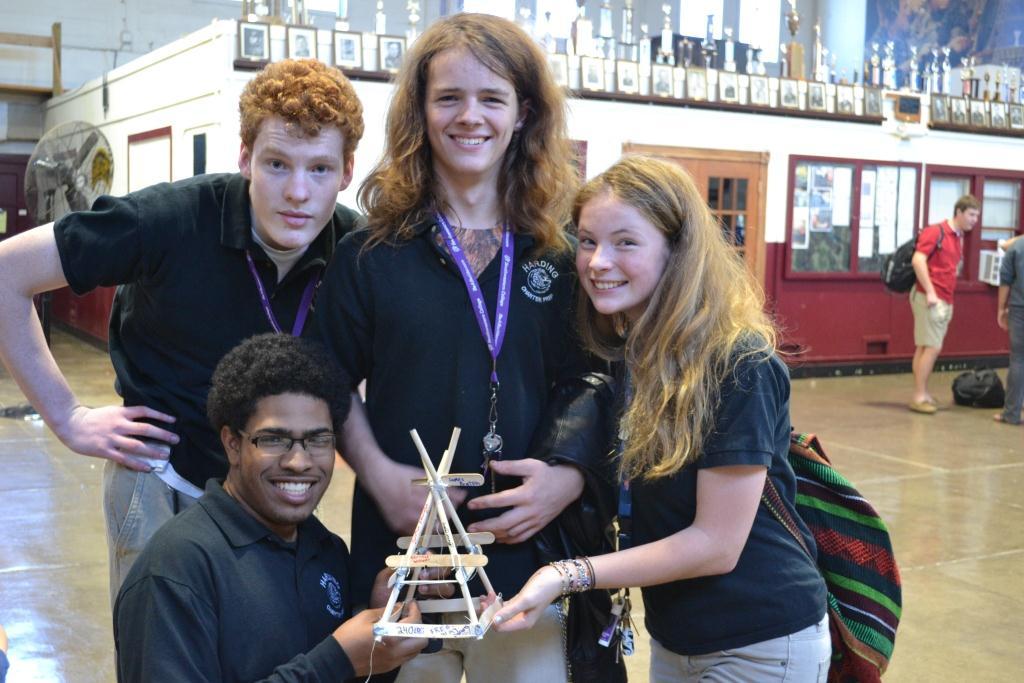 S.T.E.M. club members Christian Williams, Jonathan Etherington, James Bruton and Erica King display their successful oil derrick, which held 240 pounds.