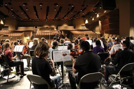 Members of the Oklahoma City All-City Orchestra rehearse with conductor Josh Klossner at Northwest Classen High School. Students from all over the city combined their talents to put on a concert that featured works by Beethoven, Rossini and Bach.