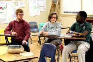 Book club members (left to right) Jarek Howell, CJ Koso, and Godwin Shokoya discuss Mark Haddon's