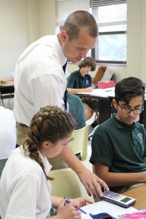 Pre-AP Conceptual Physics teacher, Clark Ellis assists a student during class.