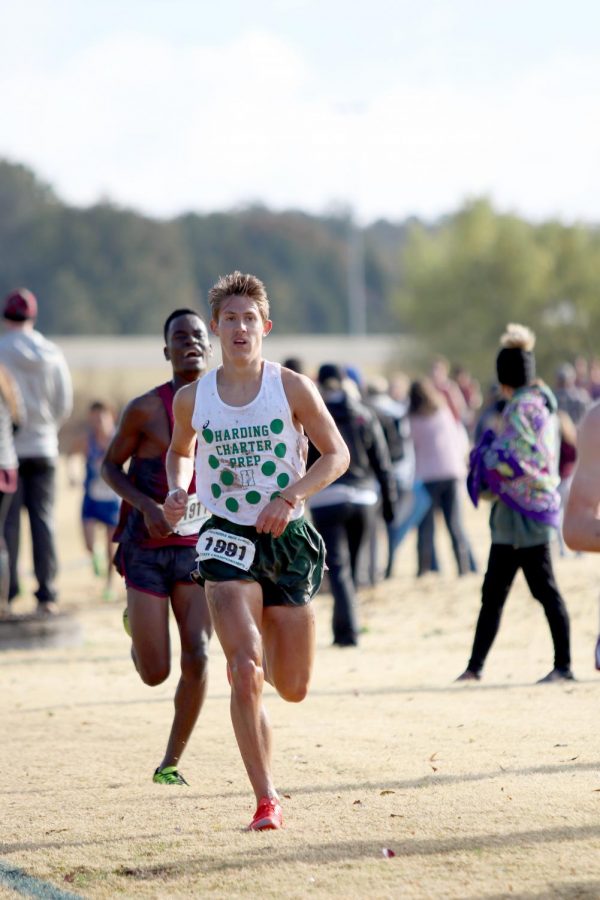 Nathan Veal, splattered with mud from the wet course, gains momentum midway through the state race.