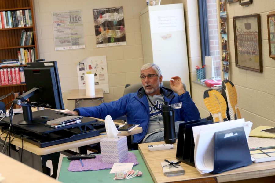 David Walsh sits behind his desk while educating his students during distance learning.