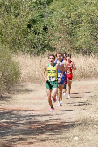 Senior Ryan McLaughlin leads the group during the first lap of the Edmond Santa Fe pre-state cross country meet on Sept. 25. McLaughlin later set a personal record and school record of 16.14 at the Chili Pepper festival in early October.
