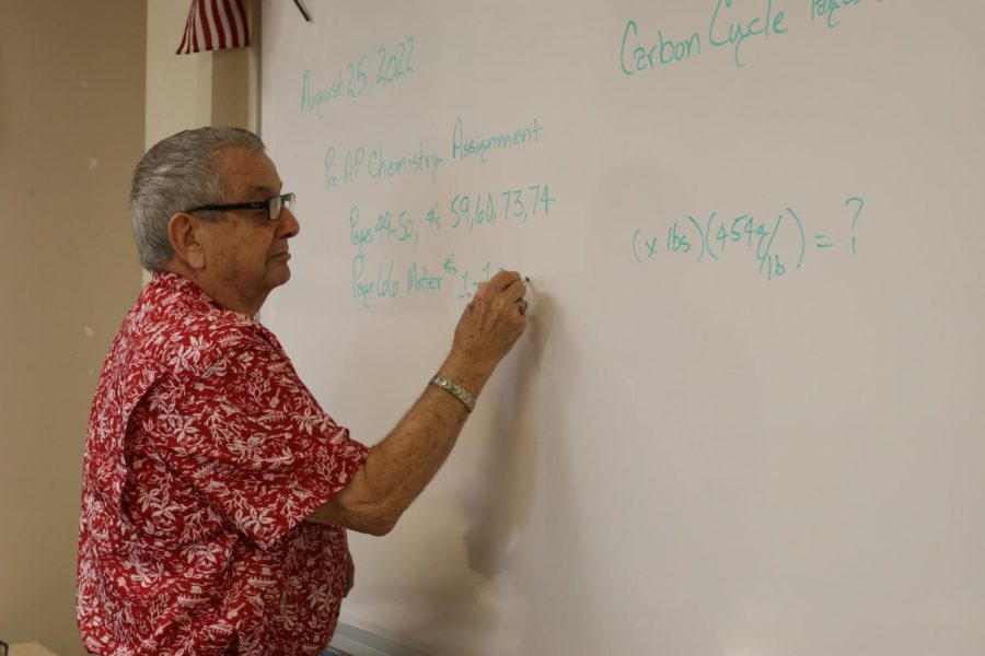 Larry Norris, new science teacher, writes some notes on the board for his class. Norris teaches AP Environmental Science and pre-AP Chemistry.