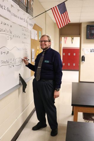 Freshman science teacher Gregory Meerschaert finishes some board work for his class. Meerschaert has rolled with the changes in class size, adding an extra table and chairs to accommodate the increase. 