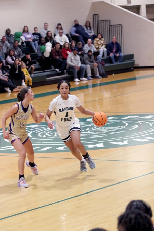 Senior Azjah Reeves charges down the court in the Homecoming game against Community Christian.