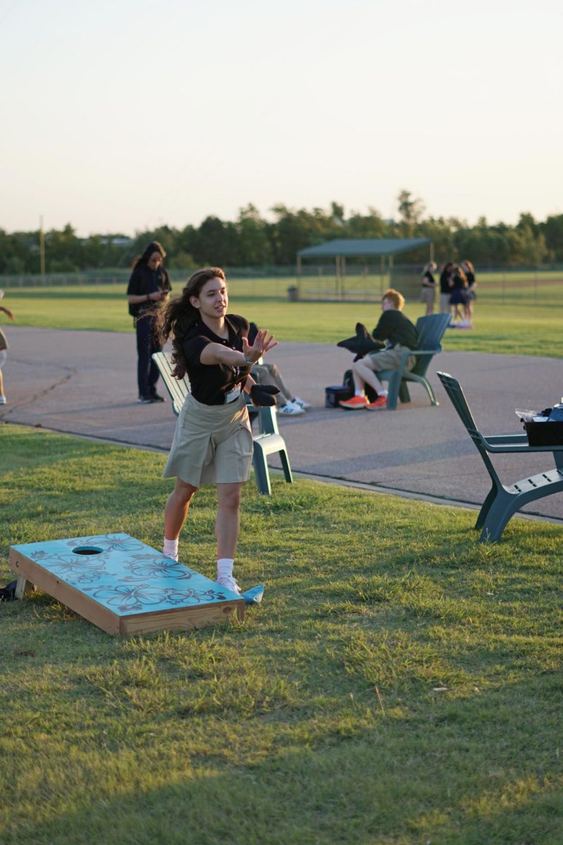 Senior Candela Principi plays the Midwest classic pasttime Cornhole during senior sunrise on Aug. 14. The Class of 2025 met before sunrise to enjoy free Chick Fil A and muffins and each others' company. "It was a great time," Principi said.