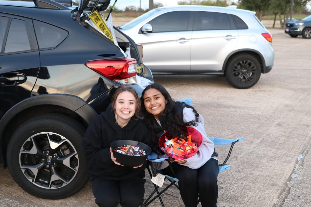 Noel Mercer and Meha Joseph hand out candy at the 2023 Trunk or Treat event sponsored by the BSU. 