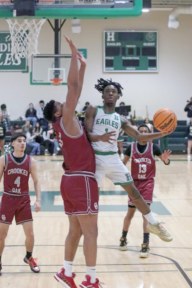 Senior Dez Nelson goes up for a layup in last home game against Crooked Oak. Although the Eagles lost in the end, seniors and royalty were still celebrated in a combined ceremony.