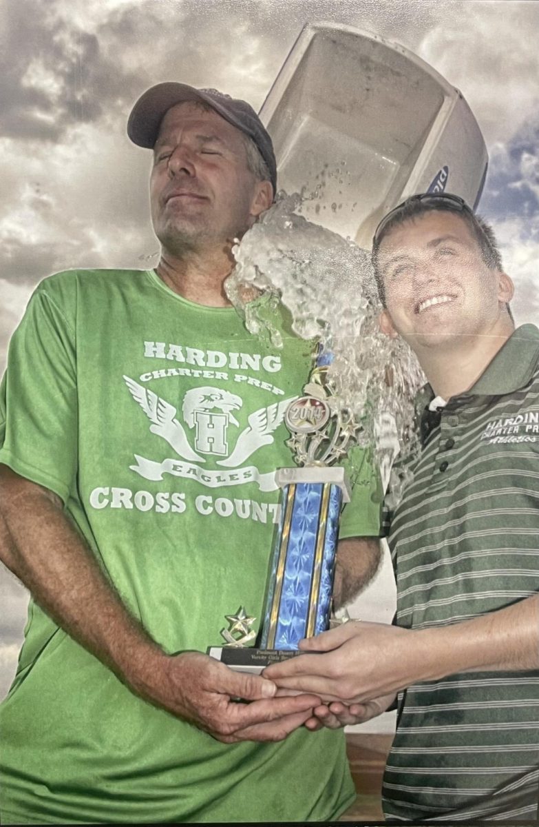 Coach Busick and Superintendent Stefanick holding trophy after winning state championship in 2014.